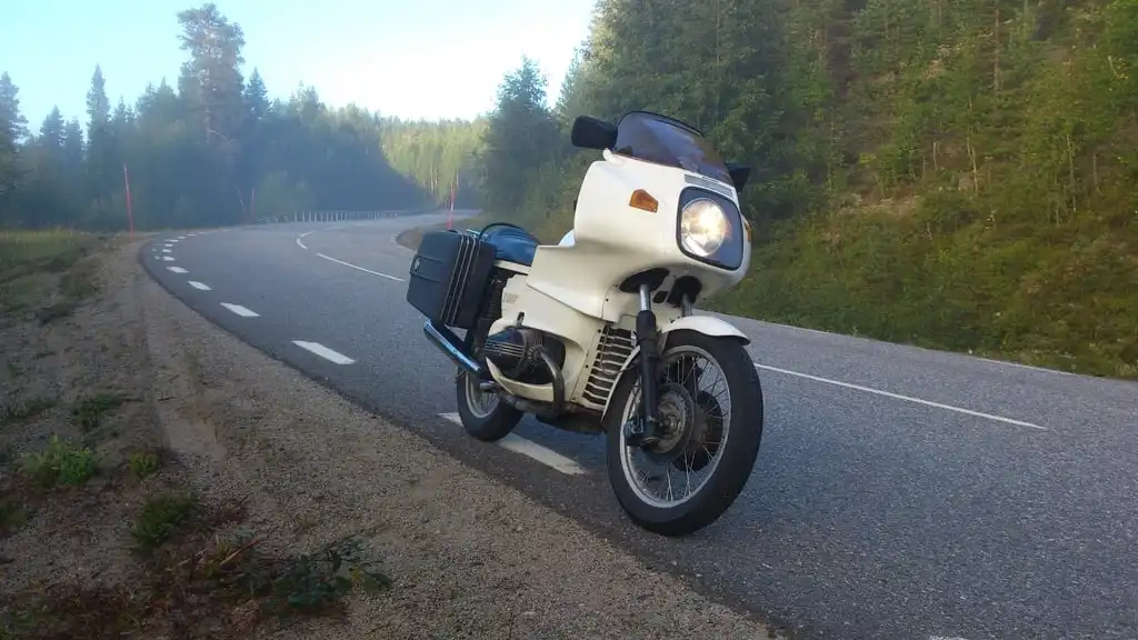 Motorcycle parked on a tree-lined road